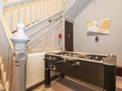 a staircase with a pool table in a room at The Kennedy House Stone Cross Mansion in Ulverston