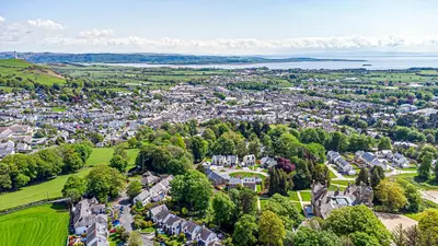an aerial view of a town with trees and houses at The Kennedy House Stone Cross Mansion in Ulverston