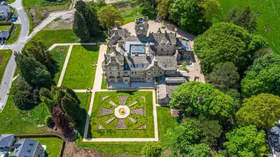 an aerial view of an estate with a large castle at The Kennedy House Stone Cross Mansion in Ulverston