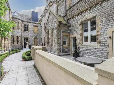 a brick building with a table in front of it at The Kennedy House Stone Cross Mansion in Ulverston