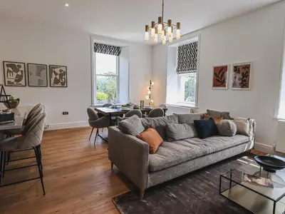 a living room with a couch and a table at The Emma Suite Stone Cross Mansion in Ulverston