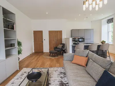 a living room with a couch and a table at The Emma Suite Stone Cross Mansion in Ulverston