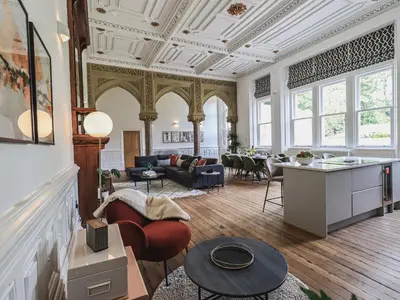 a living room with a couch and a table at The Wilfred Suite Stone Cross Mansion in Ulverston