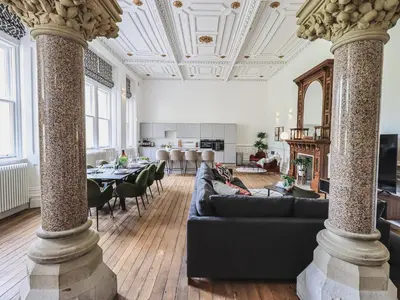a living room with a couch and a table at The Wilfred Suite Stone Cross Mansion in Ulverston