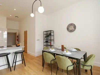 a kitchen and dining room with a table and chairs at William Tower Suite Stone Cross Mansion in Ulverston