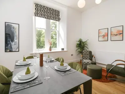 a dining room with a table and chairs at William Tower Suite Stone Cross Mansion in Ulverston