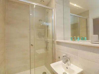 a bathroom with a shower and a sink at William Tower Suite Stone Cross Mansion in Ulverston