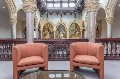 two chairs and a glass table in a building at The Lucy Suite Stone Cross Mansion in Ulverston