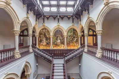 a staircase in a building with a painting on the wall at The Lucy Suite Stone Cross Mansion in Ulverston