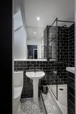 a bathroom with a sink and a toilet and a mirror at St Chads Suites by Central Beach Leisure in Blackpool
