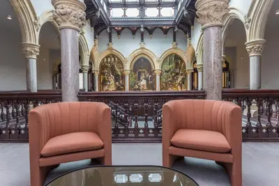 two chairs and a glass table in a building at The Mabel Suite Stone Cross Mansion in Ulverston