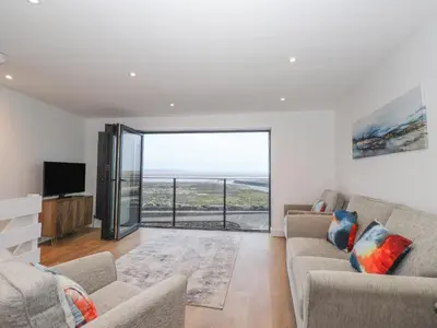 a living room with a couch and a television at The Lookout in Millom