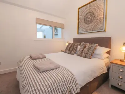 a bedroom with a bed and a window at The Lookout in Millom