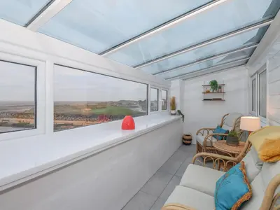 a living room with a large window and a couch at The Lookout in Millom