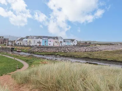 a row of houses on the shore of a river at The Lookout in Millom