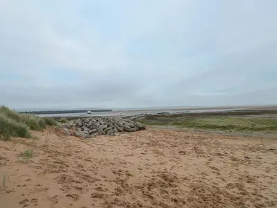 a pile of rocks sitting on a beach at The Lookout in Millom