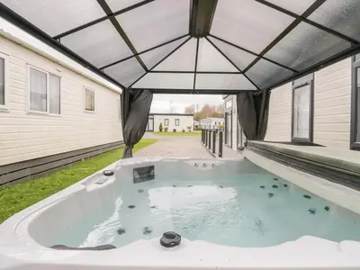 a hot tub in the backyard of a house at Yealand 36 in Carnforth