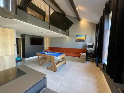 a living room with a pool table and a couch at The Luxury Penthouse by Sasco Apartments in Blackpool