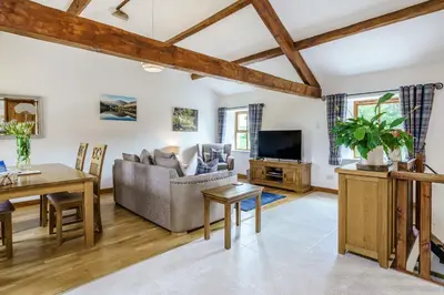 a living room with a couch and a table at Ingleborough View in Carnforth