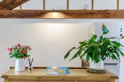two vases of flowers on top of a wooden table at Ingleborough View in Carnforth