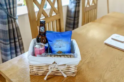 a bottle of beer in a basket on a table at Ingleborough View in Carnforth