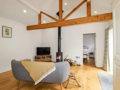 a living room with a couch and a fireplace at The Stables in Preston