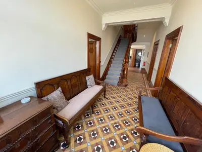a living room with a couch and a staircase at Victoria Mount in Grange Over Sands