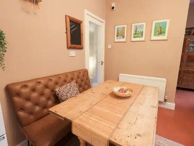 a wooden table with a bowl on top of it at Yewbarrow Cottage in Grange Over Sands