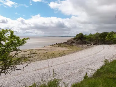 a dirt road leading to the ocean on a beach at Inglewood Court in Carnforth