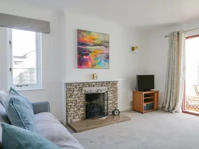 a living room with a fireplace and a tv at Westwinds in Grange Over Sands