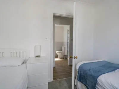 a bedroom with a bed and a bathroom with a toilet at Westwinds in Grange Over Sands