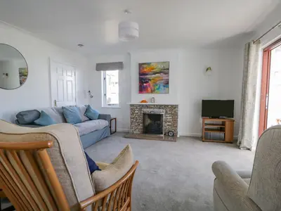 a living room with a couch and a fireplace at Westwinds in Grange Over Sands
