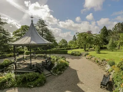a gazebo in the middle of a garden at Westwinds in Grange Over Sands