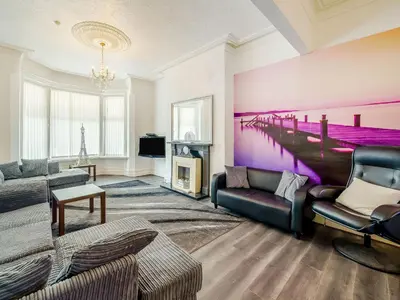 a living room with couches and a painting of a pier at Highbury in Blackpool