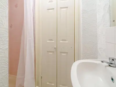 a bathroom with a sink and a white door at Highbury in Blackpool
