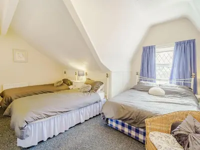 two beds in a attic room with a window at Highbury in Blackpool