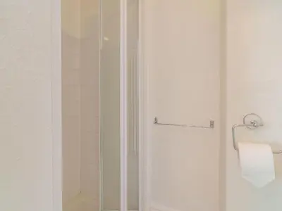 a shower with a glass door in a bathroom at Highbury in Blackpool