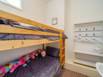 a bedroom with a bunk bed with a wooden bunk bed at Highbury in Blackpool