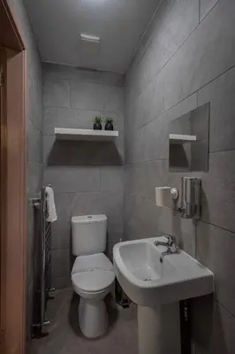 a bathroom with a white toilet and a sink at Jellyfish Apartments in Blackpool