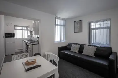 a living room with a couch and a table at Jellyfish Apartments in Blackpool