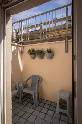a balcony with two chairs and plants on a wall at Jellyfish Apartments in Blackpool