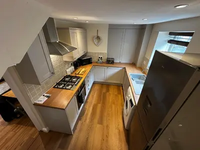 an overhead view of a kitchen with white cabinets at Whitebrook Cottage in Mellor