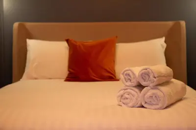 a bed with three rolled towels on it at Capri Stays - Apartment Two - Two Bed Apartment in Blackpool