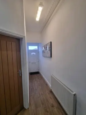 an empty room with a hallway with a door and a staircase at Cheerful 4 bedroom close to Uclan, Preston City Center in Preston