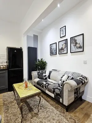 a living room with a couch and a coffee table at Cheerful 4 bedroom close to Uclan, Preston City Center in Preston