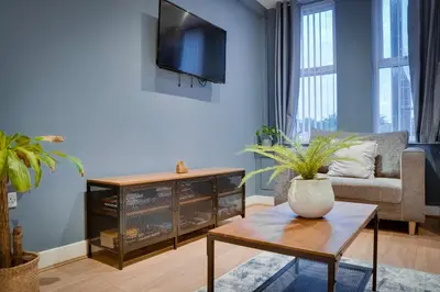 a living room with a couch and a table at Birkenhead - 2 bedroom house in Birkenhead