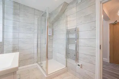 a bathroom with a shower and a sink at The Queens Arms Apartments in Liverpool