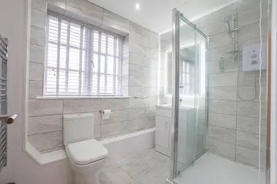 a bathroom with a toilet and a shower at The Queens Arms Apartments in Liverpool
