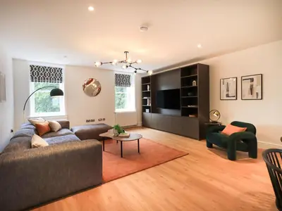 a living room with a couch and a table at The Violet Suite Stone Cross Mansion in Ulverston
