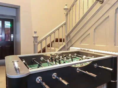 a game room with a chess board in front of a staircase at The Violet Suite Stone Cross Mansion in Ulverston